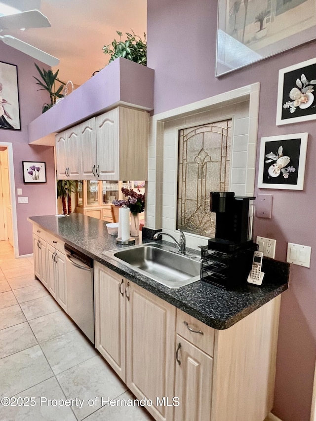 kitchen featuring light brown cabinetry, dishwasher, sink, and light tile patterned floors