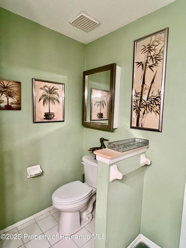 bathroom with tile patterned floors and toilet