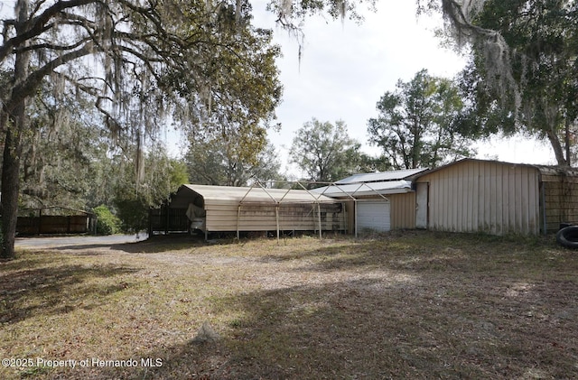 view of yard with a carport and a garage