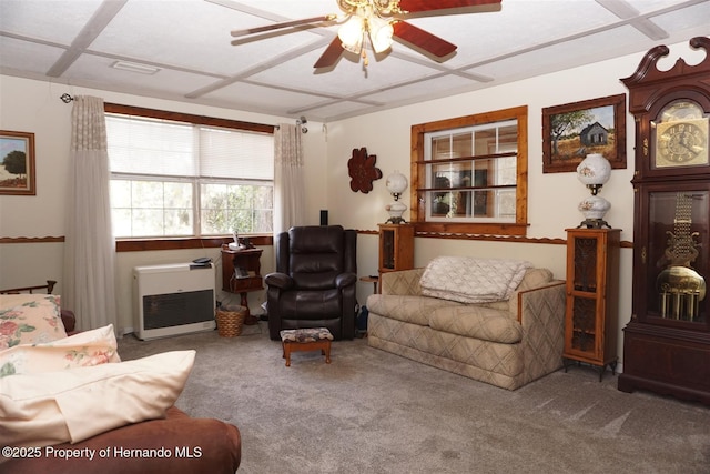 living room with ceiling fan, carpet floors, and heating unit