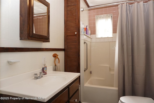 full bathroom with vanity, toilet, shower / tub combo, and tile walls