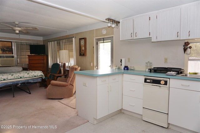 kitchen with white dishwasher, white cabinetry, kitchen peninsula, and ceiling fan