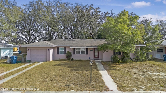 view of front of home with a garage and a front lawn