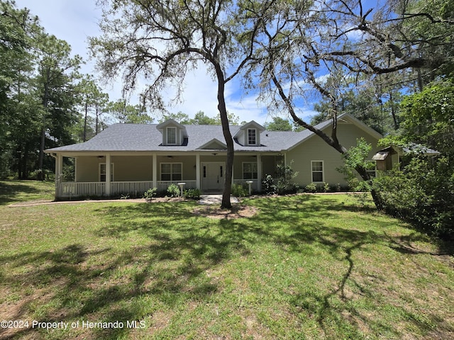 back of house with a yard and a porch