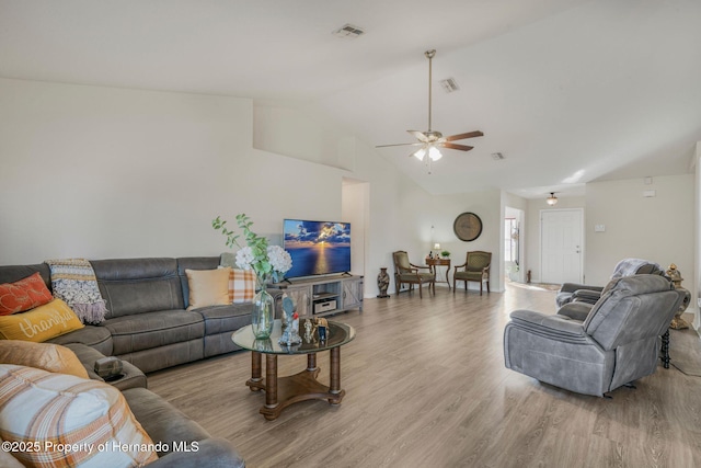 living room featuring ceiling fan, lofted ceiling, and light hardwood / wood-style floors