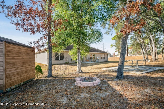 view of yard featuring an outdoor fire pit