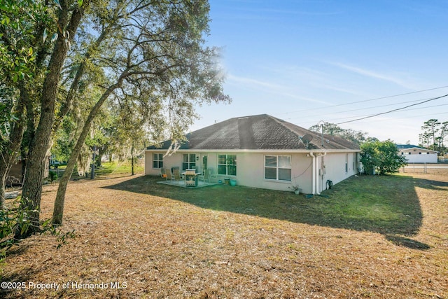 rear view of house with a yard and a patio area