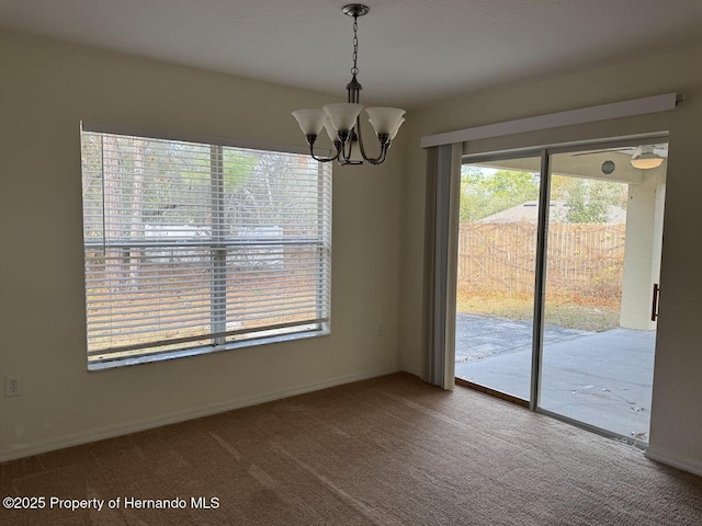 unfurnished dining area with an inviting chandelier and carpet flooring