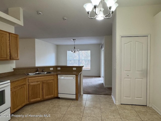 kitchen with sink, an inviting chandelier, hanging light fixtures, light tile patterned floors, and white appliances