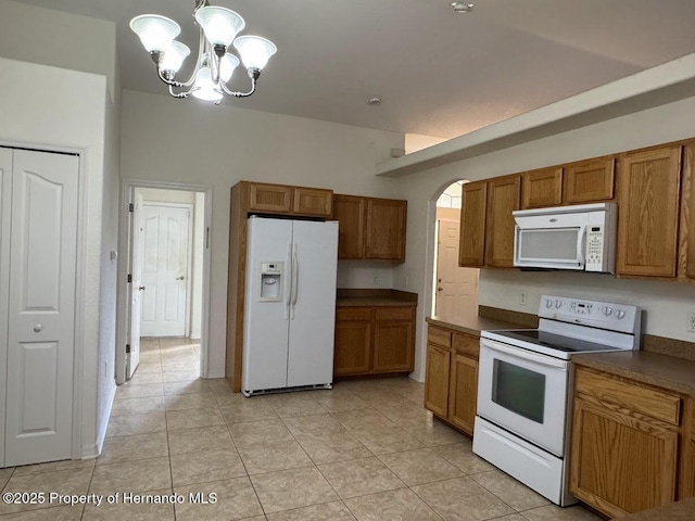 kitchen featuring hanging light fixtures, an inviting chandelier, white appliances, and light tile patterned floors