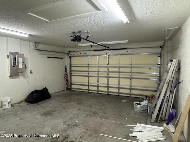 garage with a garage door opener and electric panel