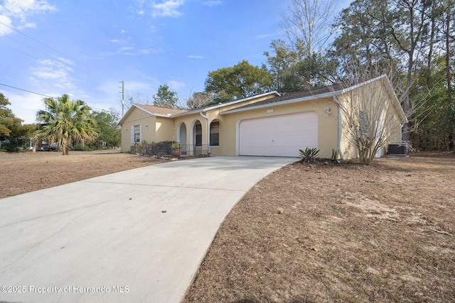 ranch-style house with central AC and a garage