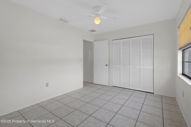 unfurnished bedroom with a closet and ceiling fan