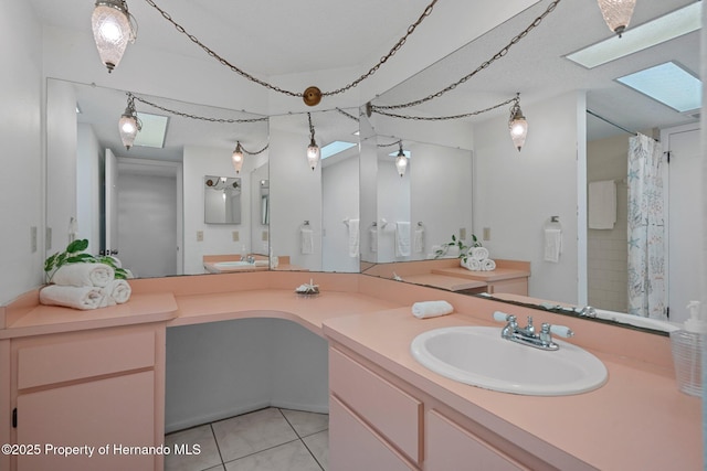 bathroom featuring vanity, curtained shower, tile patterned floors, and a skylight