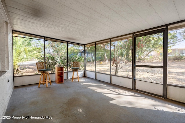 unfurnished sunroom featuring a healthy amount of sunlight