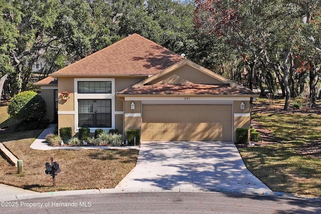 view of front facade featuring a garage and a front lawn