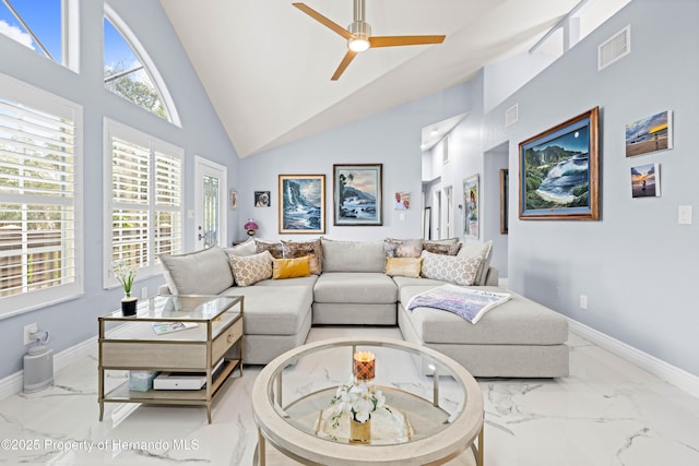 living area with high vaulted ceiling, marble finish floor, visible vents, a ceiling fan, and baseboards