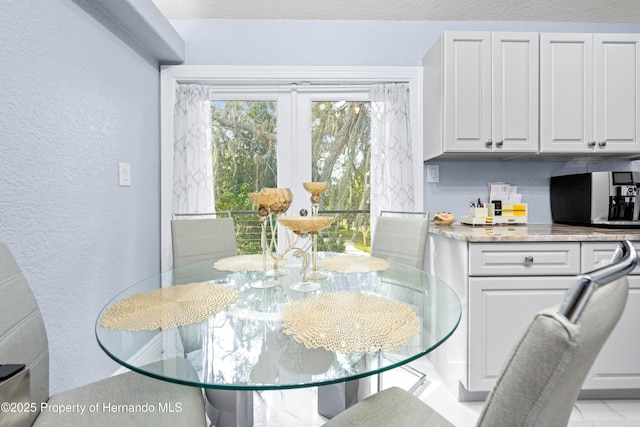 dining area with a textured wall