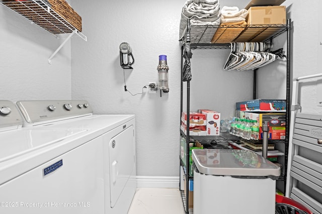 clothes washing area featuring washing machine and clothes dryer and laundry area