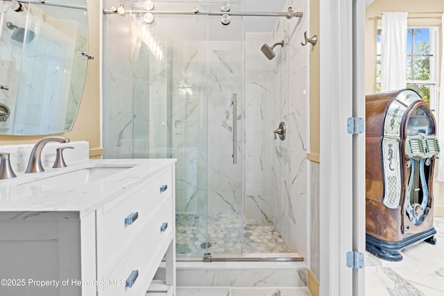 full bathroom with vanity, marble finish floor, and a marble finish shower
