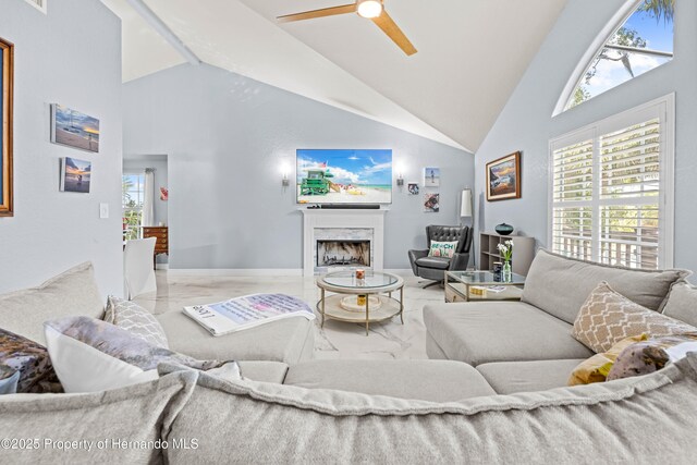 living room with a fireplace, ceiling fan, high vaulted ceiling, and marble finish floor