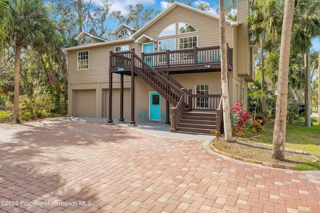 view of front of house with a garage and a wooden deck