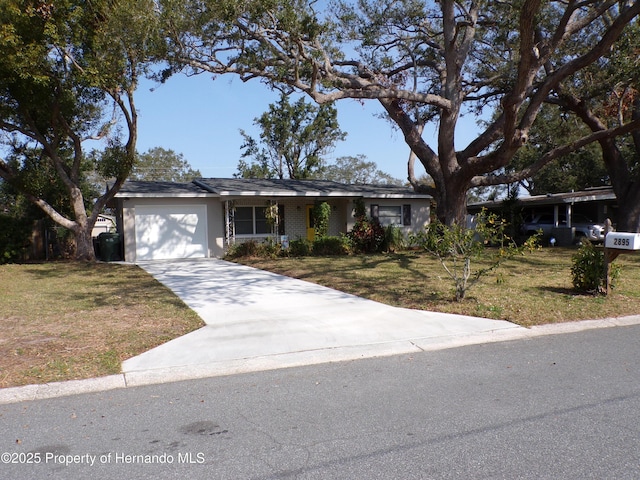 ranch-style home featuring a garage and a front lawn