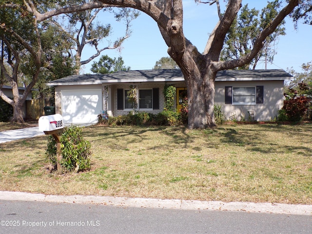 single story home with a garage and a front yard