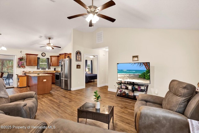 living room with wood-type flooring, lofted ceiling, and ceiling fan