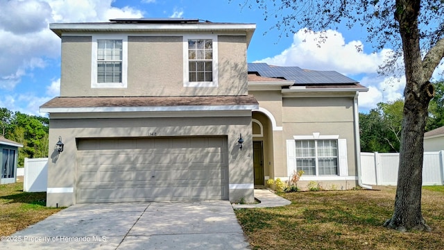 front of property featuring a garage, a front lawn, and solar panels