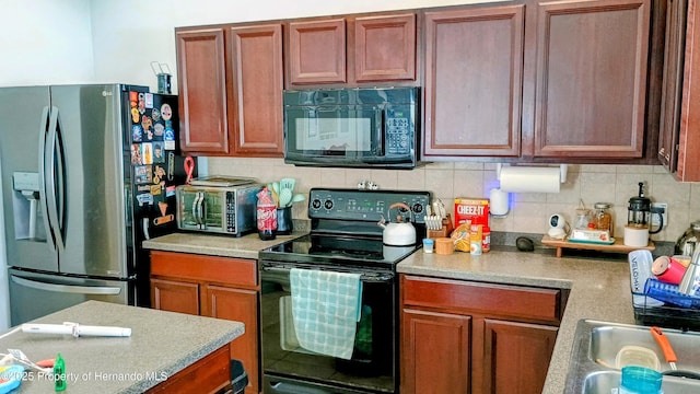 kitchen featuring tasteful backsplash and black appliances