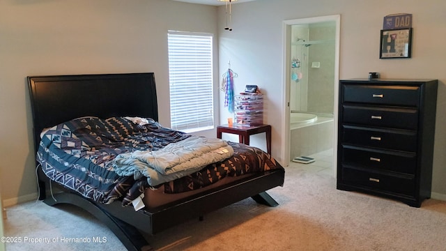 bedroom with ensuite bath and light colored carpet