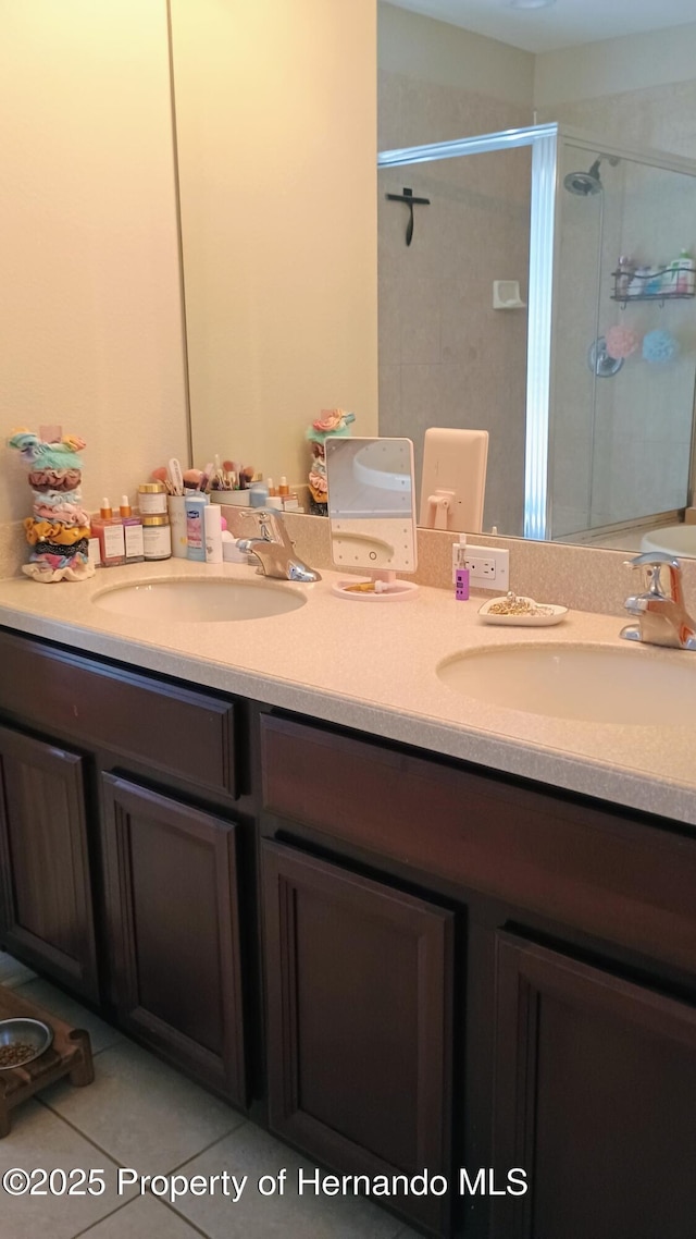 bathroom featuring vanity, tile patterned floors, and a shower with shower door