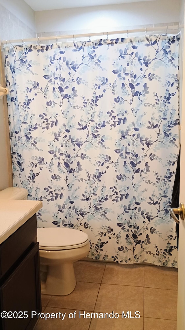 bathroom with vanity, tile patterned floors, and toilet