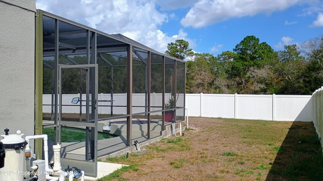 view of yard with a fenced in pool and glass enclosure