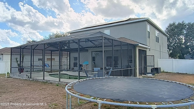 back of house with a pool, a lanai, and a patio area