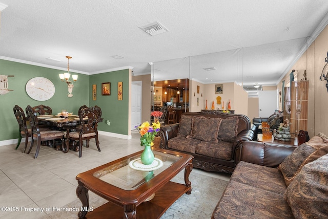 tiled living room featuring ornamental molding, an inviting chandelier, and a textured ceiling