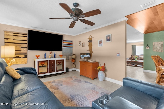 living room featuring ornamental molding, light tile patterned floors, and ceiling fan