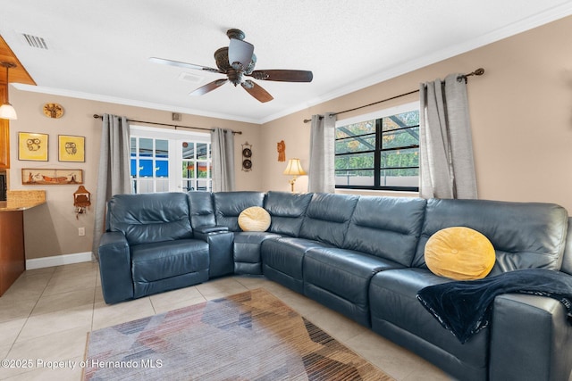 tiled living room featuring crown molding, a healthy amount of sunlight, and ceiling fan