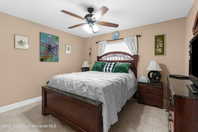 tiled bedroom featuring ceiling fan