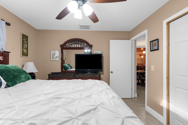 tiled bedroom with ceiling fan