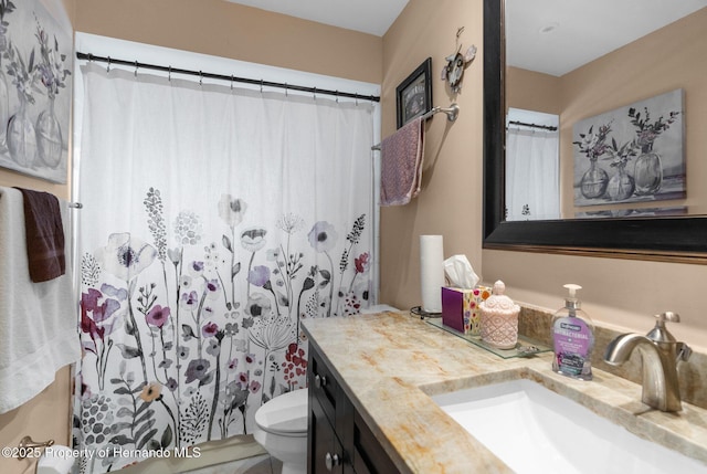 bathroom with vanity, walk in shower, and toilet