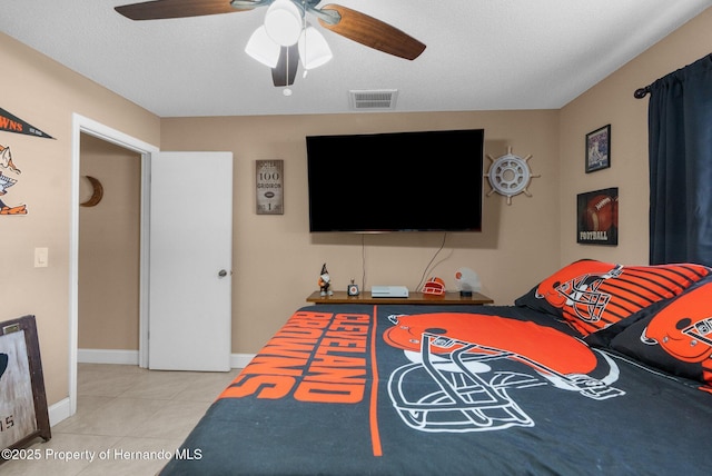 tiled bedroom featuring a textured ceiling and ceiling fan