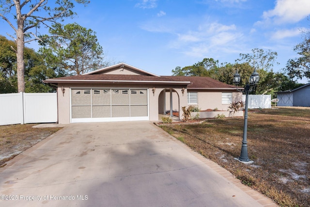 ranch-style home featuring a garage and a front yard