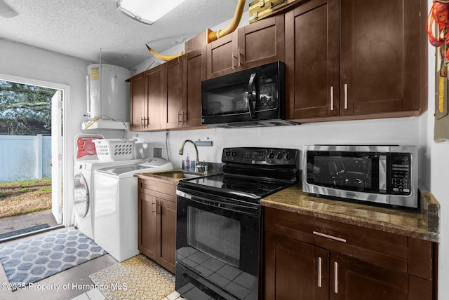 kitchen featuring sink, washer and clothes dryer, water heater, dark stone countertops, and black appliances