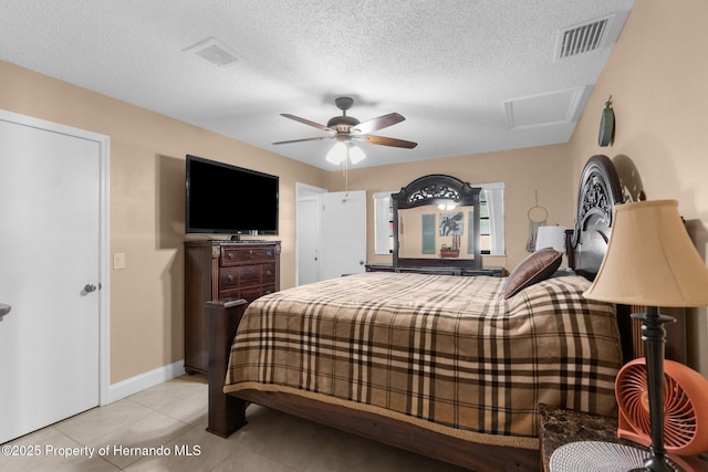 tiled bedroom featuring ceiling fan and a textured ceiling