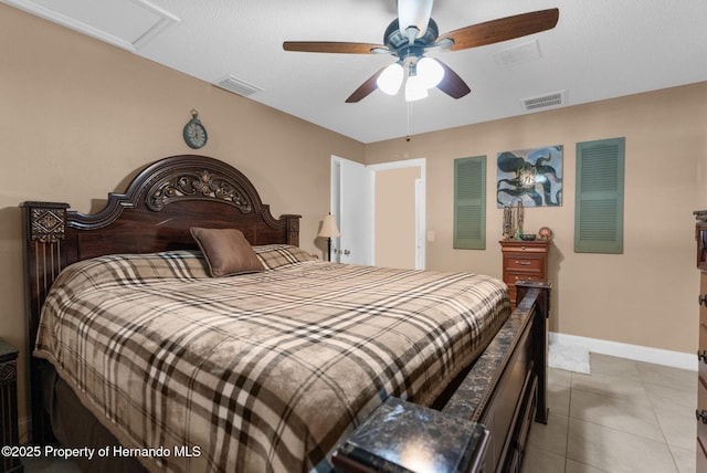 tiled bedroom featuring ceiling fan