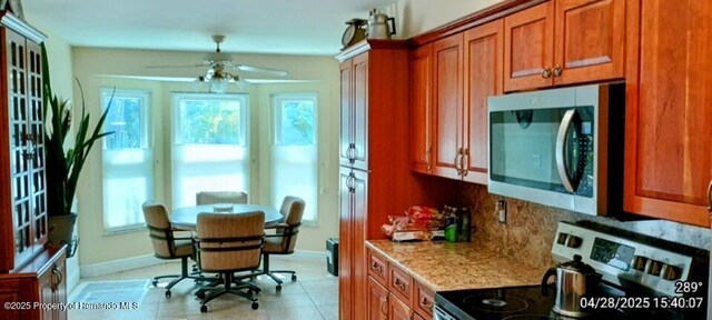 kitchen featuring brown cabinets, ceiling fan, and appliances with stainless steel finishes