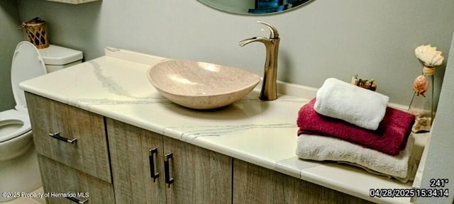 room details with vanity, toilet, and baseboards
