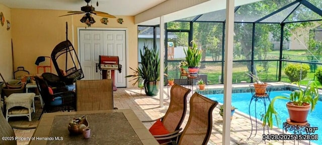 exterior space with a lanai, ceiling fan, and a patio area